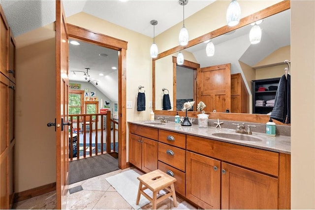 bathroom featuring a textured ceiling, tile patterned flooring, vanity, and vaulted ceiling