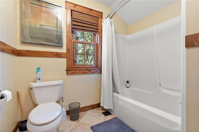 bathroom featuring shower / tub combo with curtain, toilet, and tile patterned floors