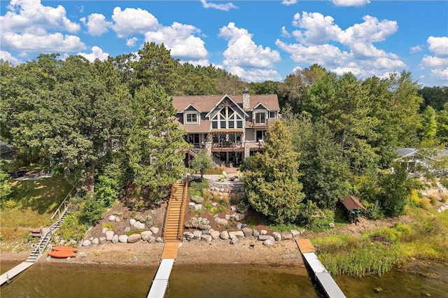 rear view of house with a deck with water view