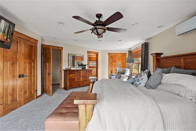 carpeted bedroom featuring ceiling fan and a wall mounted AC