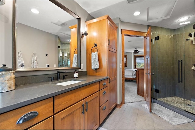 bathroom featuring vanity, ceiling fan, tile patterned floors, and a shower with shower door