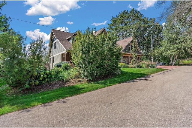 view of side of property with a lawn