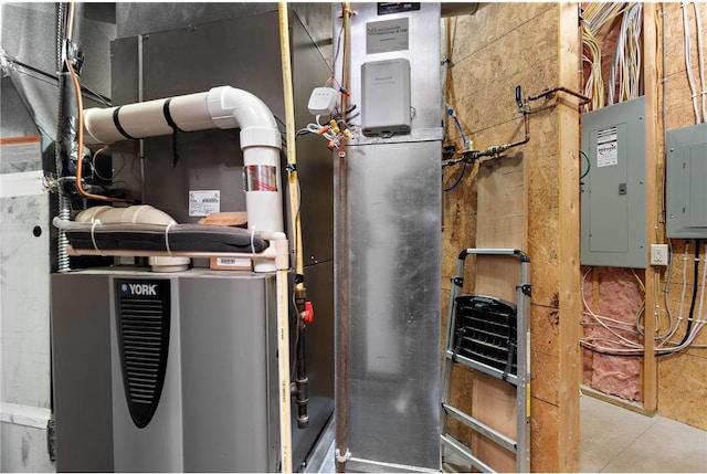 utility room featuring electric panel and heating unit