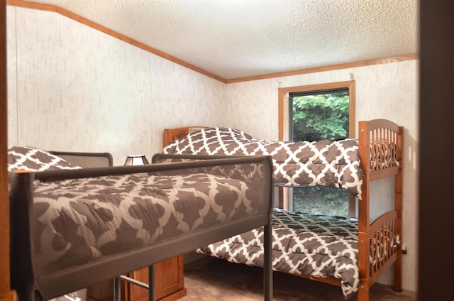 bedroom featuring a textured ceiling and ornamental molding