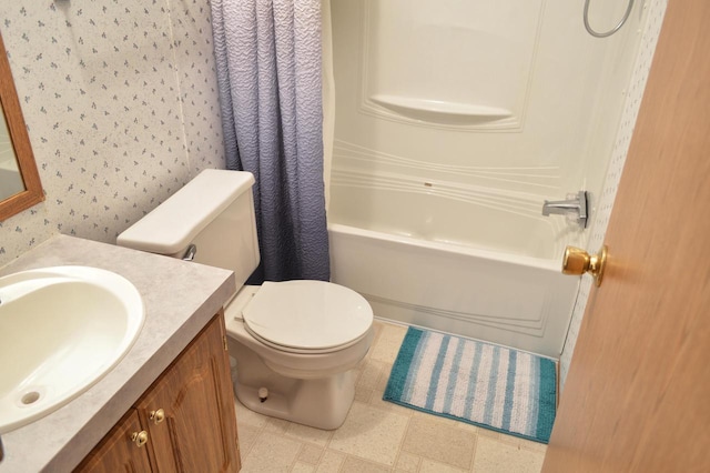 full bathroom with vanity, shower / tub combo, and toilet