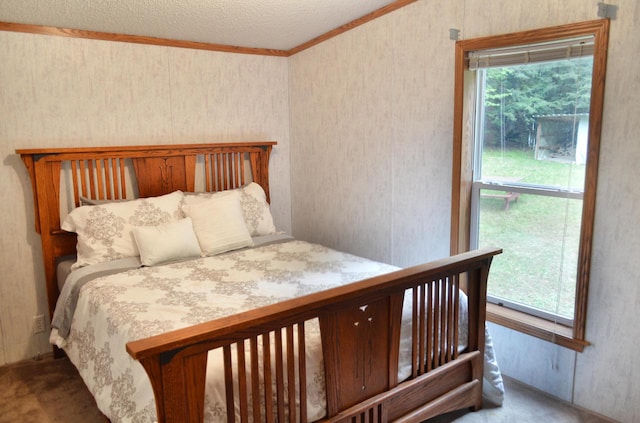 bedroom with a textured ceiling, multiple windows, carpet floors, and crown molding