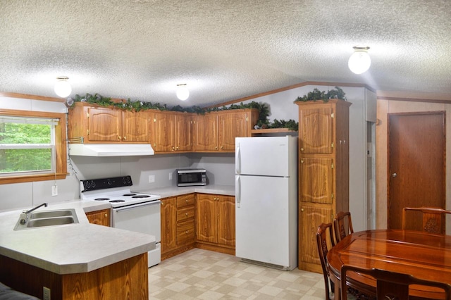 kitchen with kitchen peninsula, white appliances, a textured ceiling, and vaulted ceiling