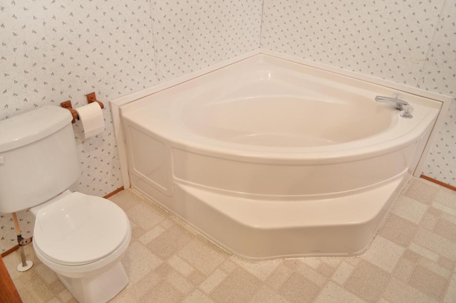 bathroom featuring a bathing tub and toilet