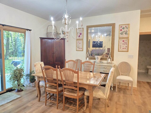 dining area featuring light hardwood / wood-style floors and a chandelier