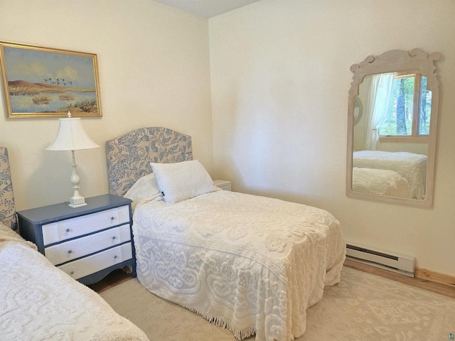 carpeted bedroom with a baseboard radiator