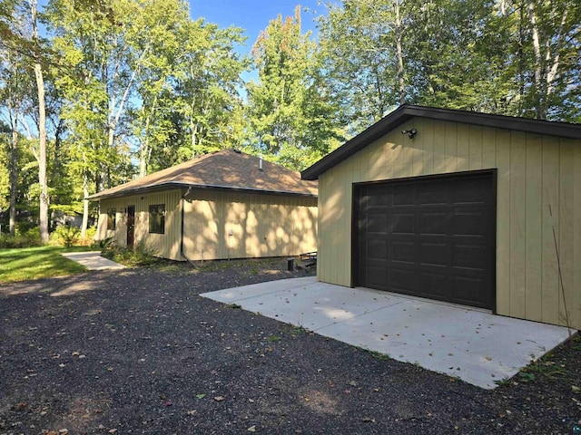 garage featuring wooden walls