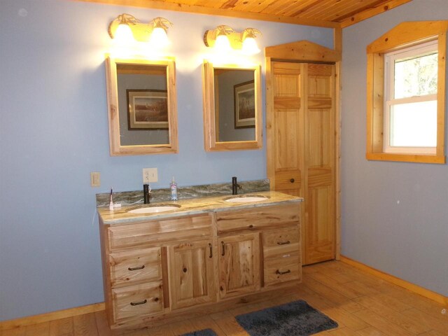 bathroom featuring wood ceiling, hardwood / wood-style floors, and vanity