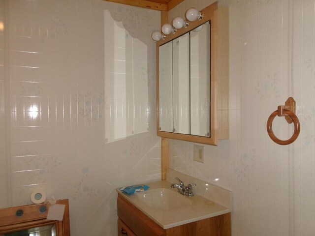 bathroom with tile walls and vanity