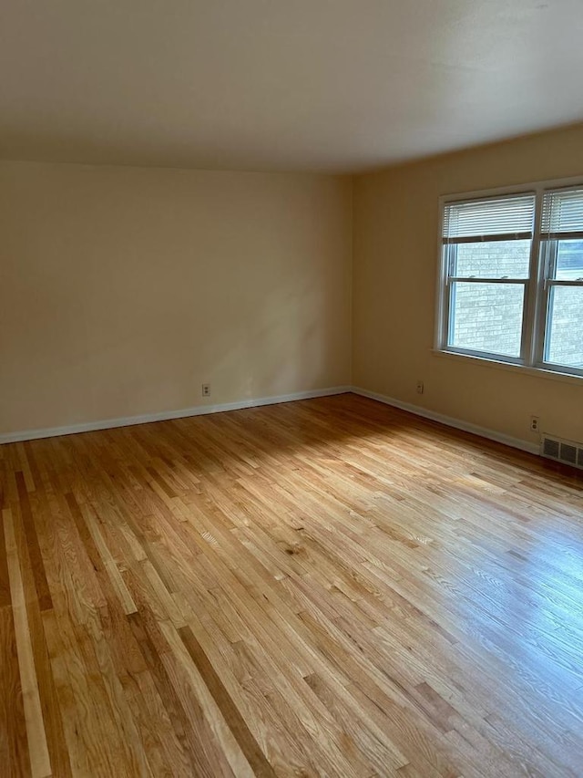 spare room with light hardwood / wood-style floors