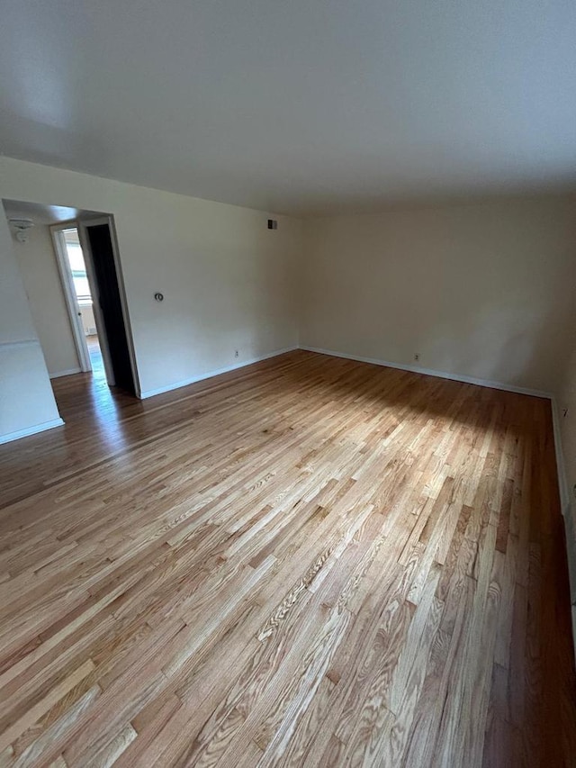 empty room with light hardwood / wood-style flooring