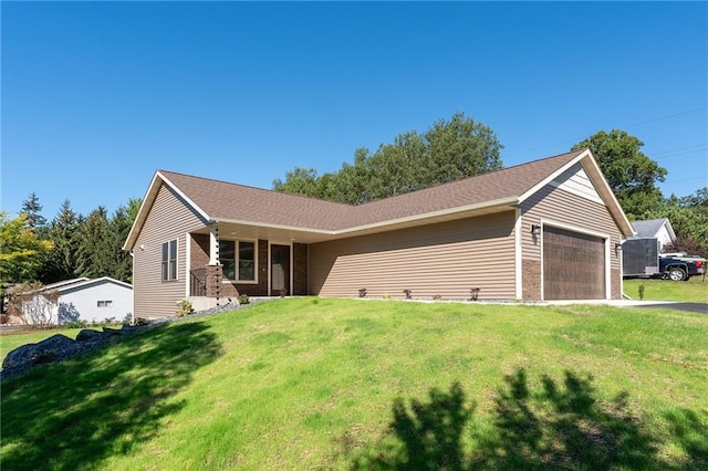 ranch-style home with a garage and a front lawn