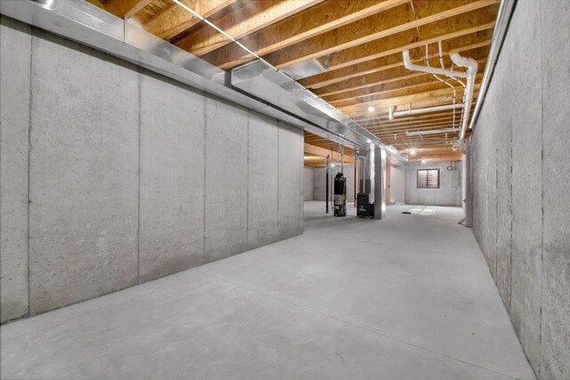 basement with water heater and heating unit