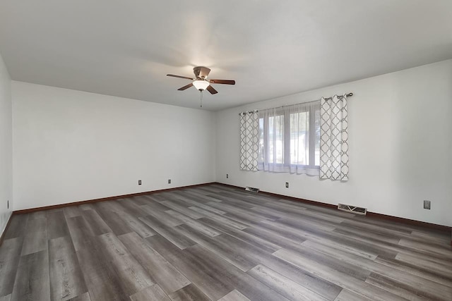 empty room with hardwood / wood-style flooring and ceiling fan