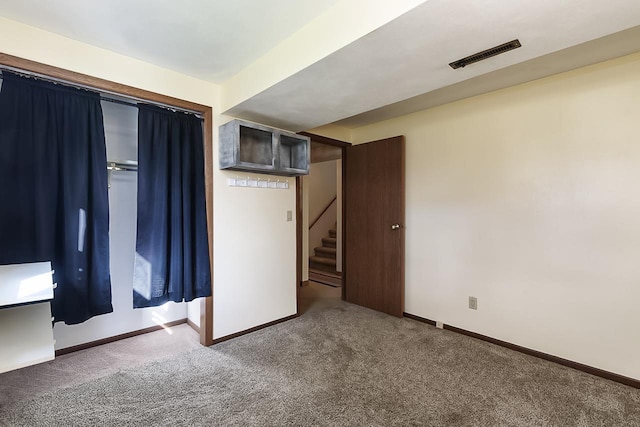 unfurnished bedroom featuring dark carpet