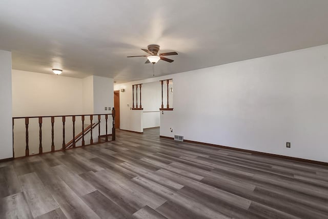 spare room featuring dark hardwood / wood-style flooring and ceiling fan