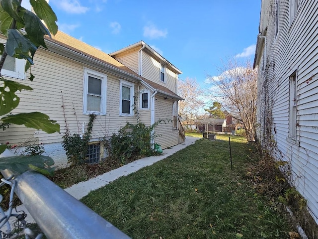 view of side of home featuring a lawn