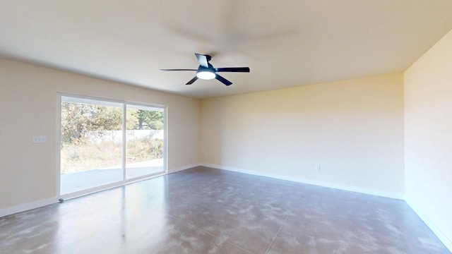 unfurnished room featuring ceiling fan, finished concrete flooring, and baseboards