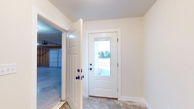 entryway with concrete floors and baseboards