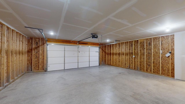 garage featuring wooden walls and a garage door opener