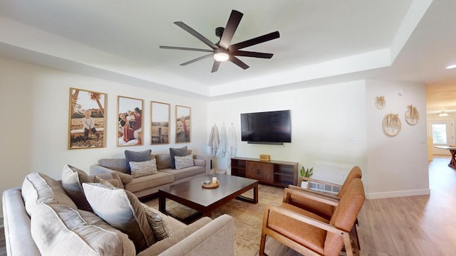 living room featuring ceiling fan and light hardwood / wood-style flooring