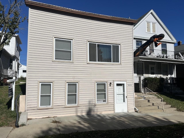 back of house with a balcony