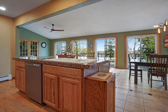 kitchen with ceiling fan, light tile patterned floors, a kitchen island with sink, dishwasher, and vaulted ceiling