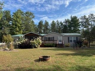 W4706 29th St, Necedah, WI 54646 - manufactured / mobile home with an outdoor fire pit, a wooden deck, and a front yard