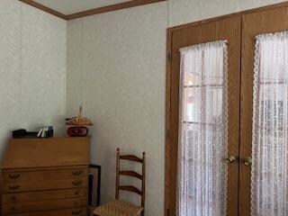 bedroom featuring ornamental molding and french doors