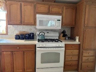 kitchen with white appliances and tasteful backsplash