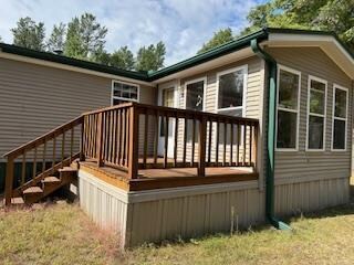 back of house with a wooden deck