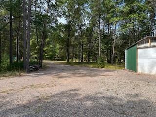 view of yard featuring an outdoor structure and a garage