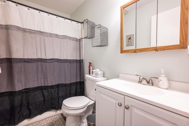 bathroom with a textured ceiling, vanity, toilet, and a shower with curtain