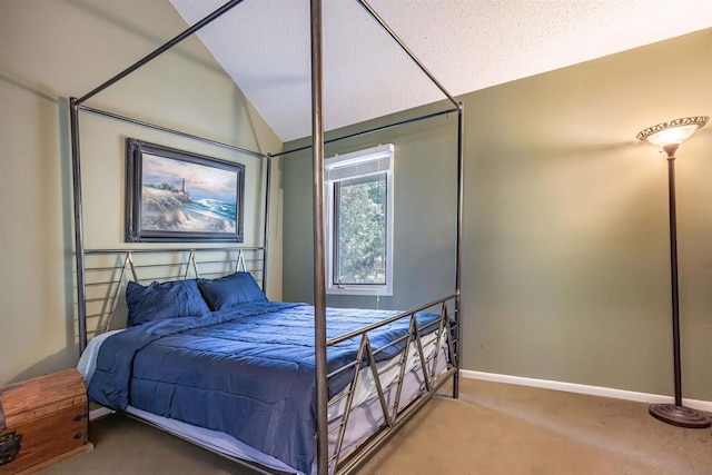 bedroom with lofted ceiling, a textured ceiling, and carpet floors