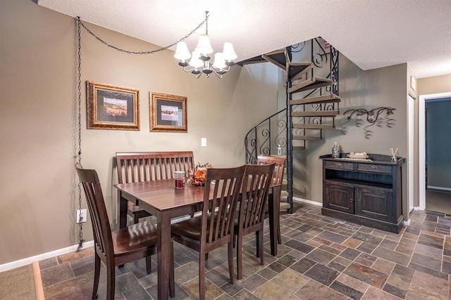 dining area featuring a textured ceiling and an inviting chandelier