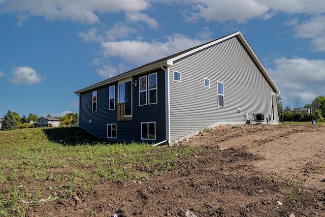 view of side of property featuring central AC unit