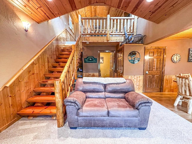 living room with wooden ceiling, hardwood / wood-style floors, and high vaulted ceiling