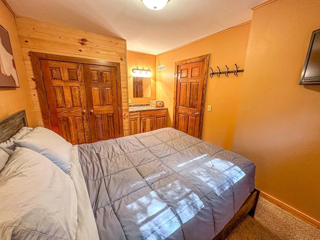 bedroom featuring connected bathroom and carpet