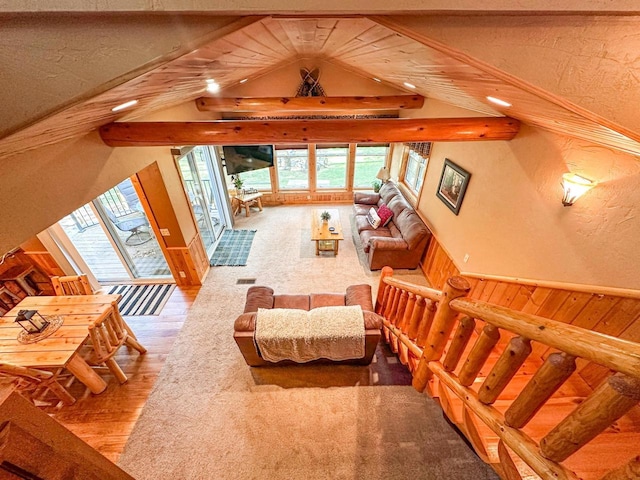 living room with beamed ceiling, wood walls, and hardwood / wood-style floors