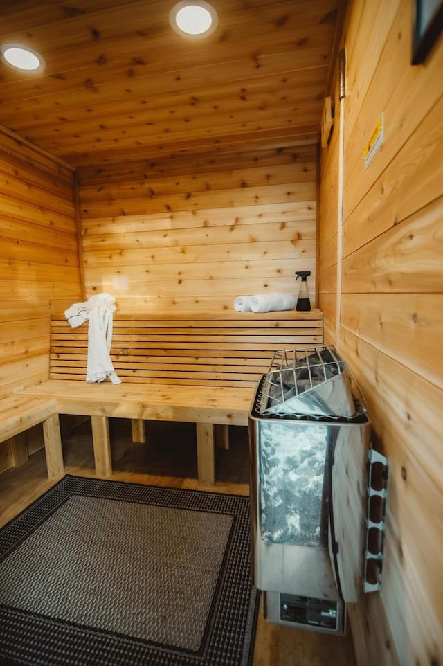 view of sauna with wood walls and wooden ceiling