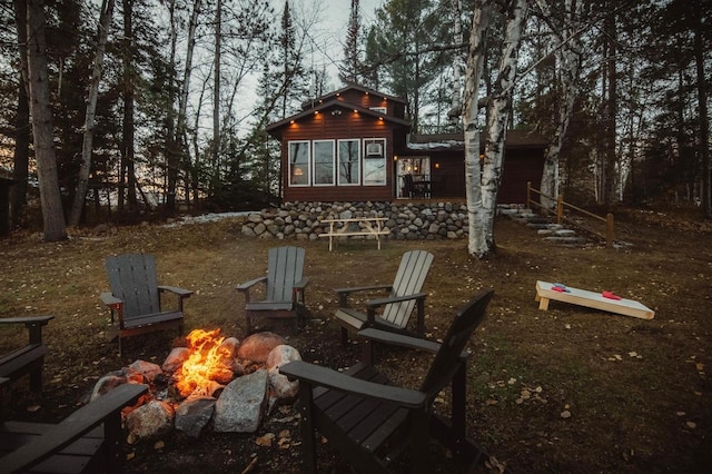 back of property featuring an outdoor fire pit