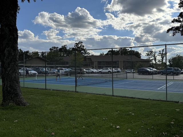 view of sport court featuring a lawn