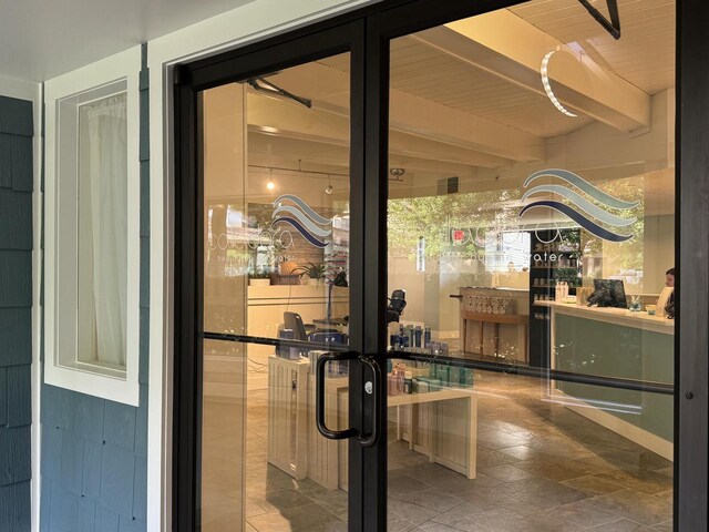 interior space with beam ceiling and wooden ceiling