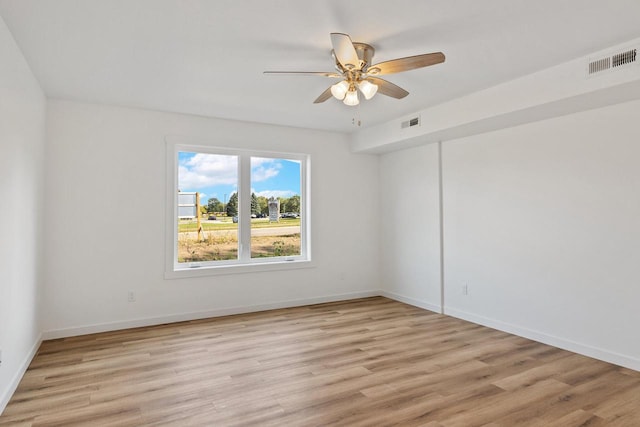 empty room with ceiling fan, visible vents, and light wood-style flooring