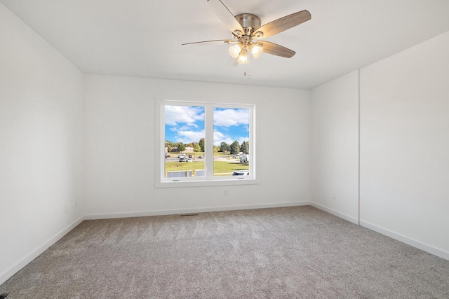 carpeted empty room with baseboards and ceiling fan