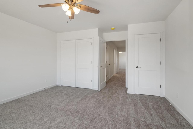 unfurnished bedroom with a closet, ceiling fan, and light colored carpet